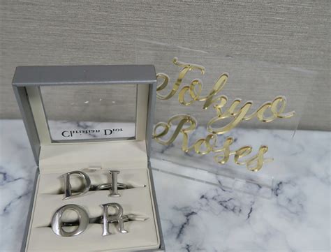 dior block letter ring.